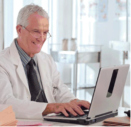 Picture of a man with a white coat using a laptop